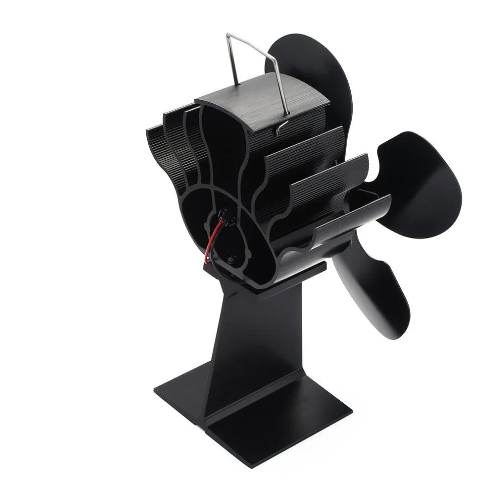 Black Yotsuba style thermodynamic fireplace fan on a hearth.