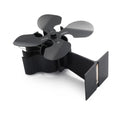 Black Yotsuba style thermodynamic fireplace fan on a hearth.
