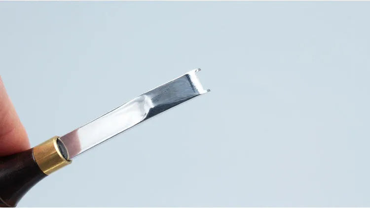 Professional hair thinning knife with leather handle, showing sectional cutting and wide shovel edges.