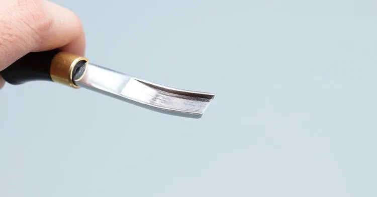 Professional hair thinning knife with leather handle, showing sectional cutting and wide shovel edges.