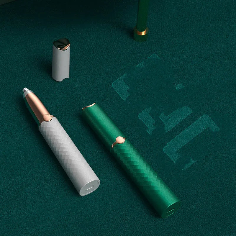 Electric eyebrow trimmer in white with LED light, rechargeable battery, and USB cable on a clean surface