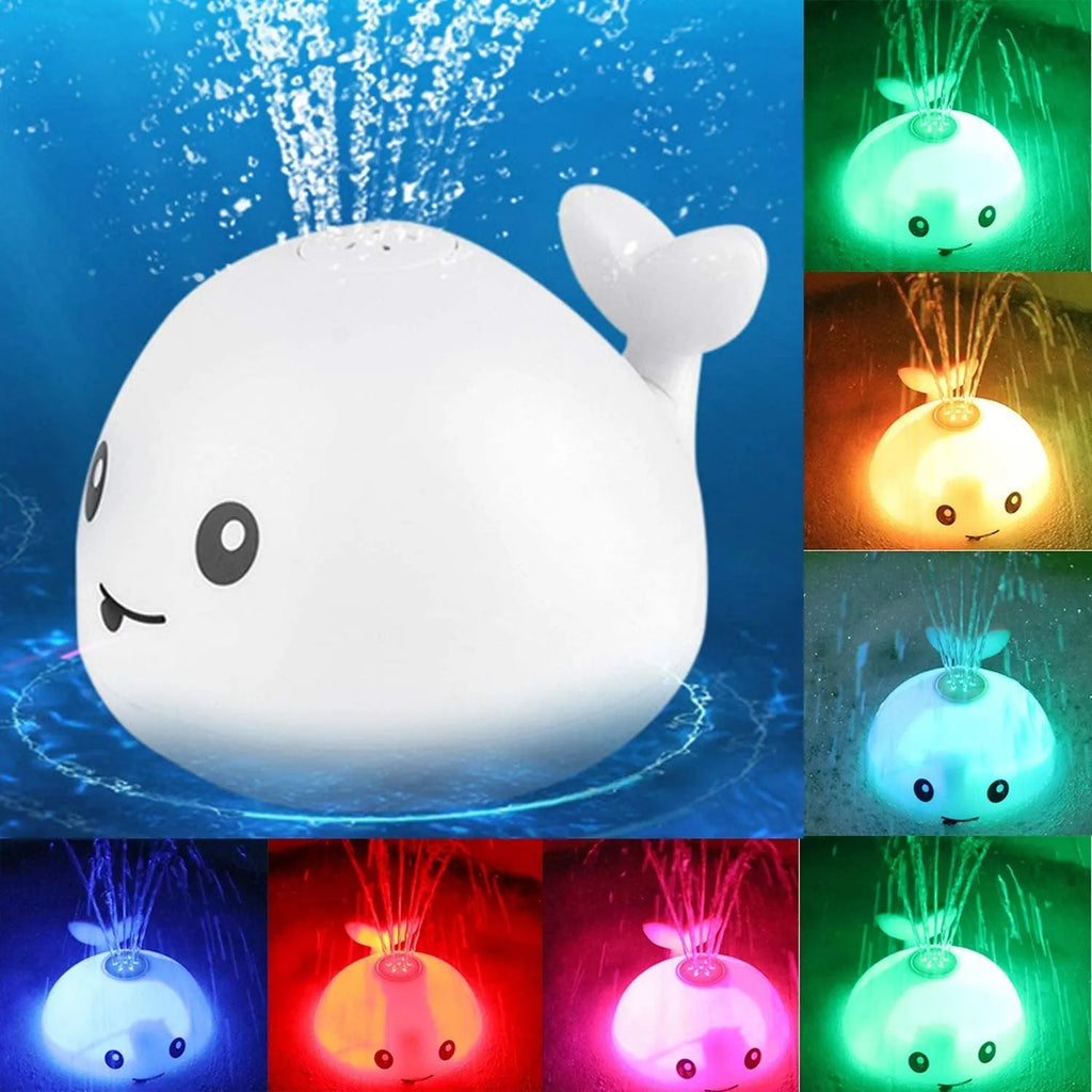 Whale-shaped electric bath toy spraying water with flashing lights, floating in baby bathtub