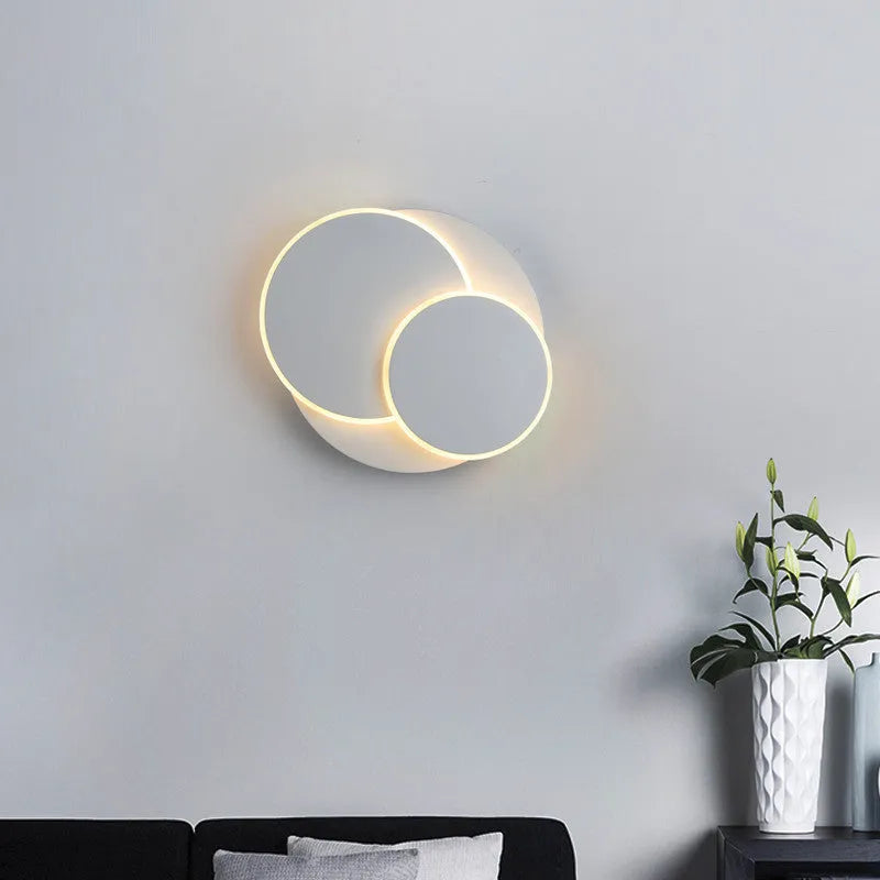 Modern round acrylic wall lamp in black or white, shown in three different sizes.