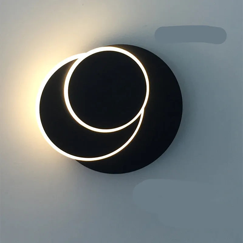Modern round acrylic wall lamp in black or white, shown in three different sizes.