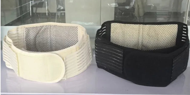 Black elastic self-heating waist belt with magnetic therapy laid flat.
