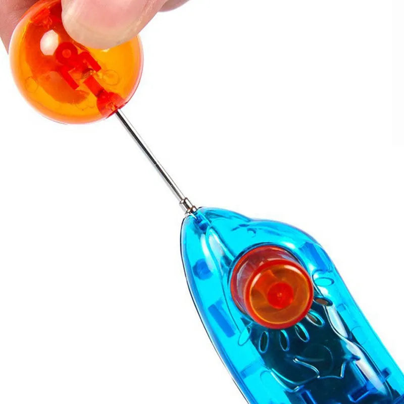 Blue plastic dog training clicker on a light surface for pet obedience training