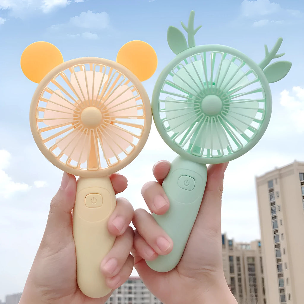 A cartoon-style hand-held USB rechargeable fan shown in blue, green, pink, and yellow colour options.