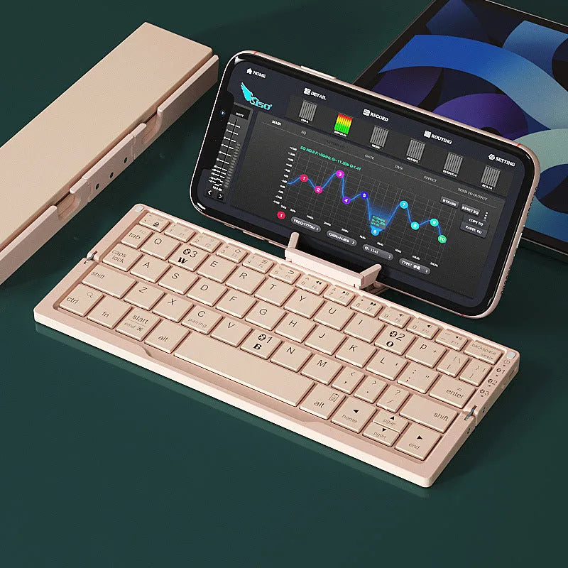Folded aluminium Bluetooth keyboard showing compact size next to unfolded version with tablet on stand