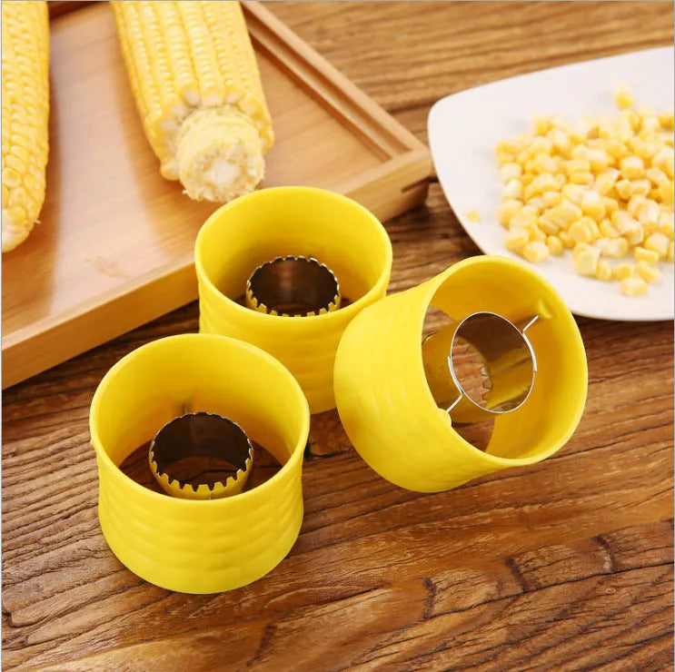 Yellow manual corn grinder thresher with corn-shaped design and stainless steel peeling gear.