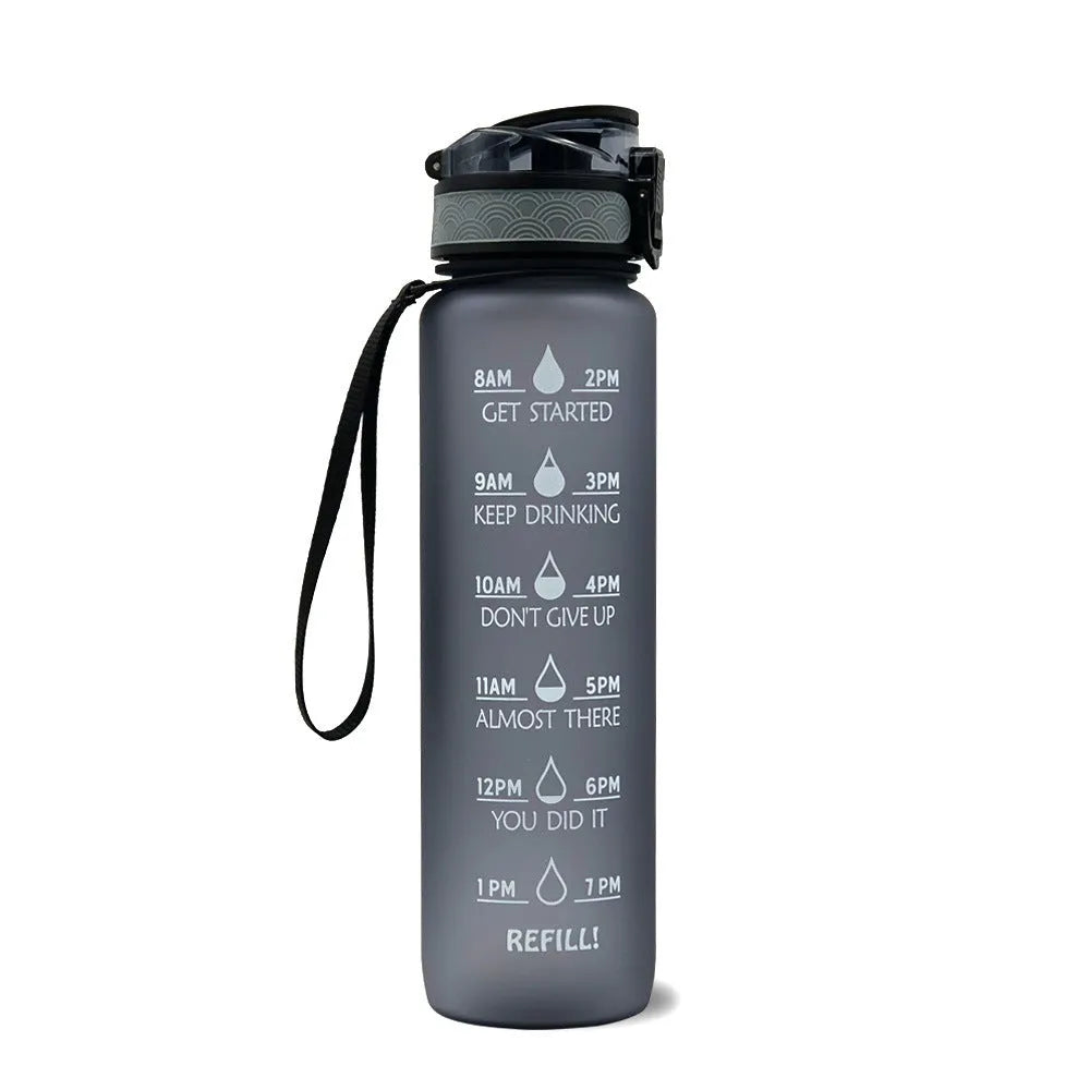 Blue and red gradient 1 litre Tritan sports water bottle with time markers and a black flip-top lid.