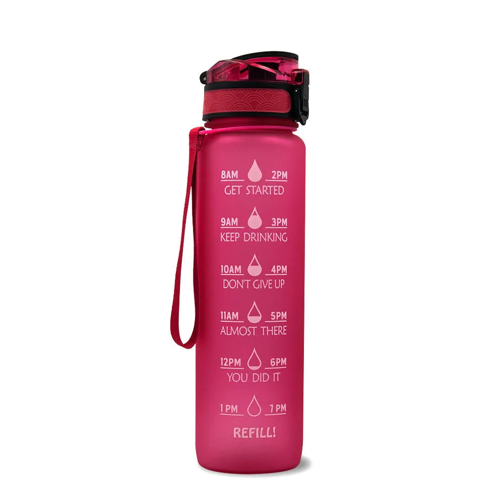 Blue and red gradient 1 litre Tritan sports water bottle with time markers and a black flip-top lid.