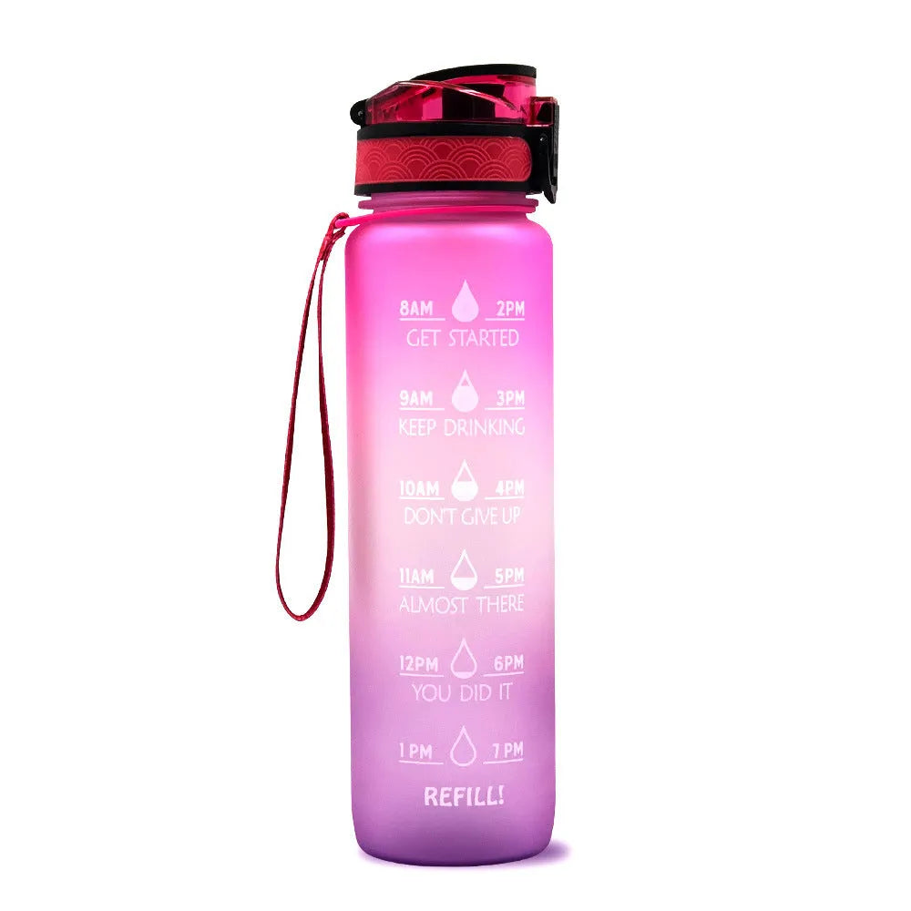 Blue and red gradient 1 litre Tritan sports water bottle with time markers and a black flip-top lid.