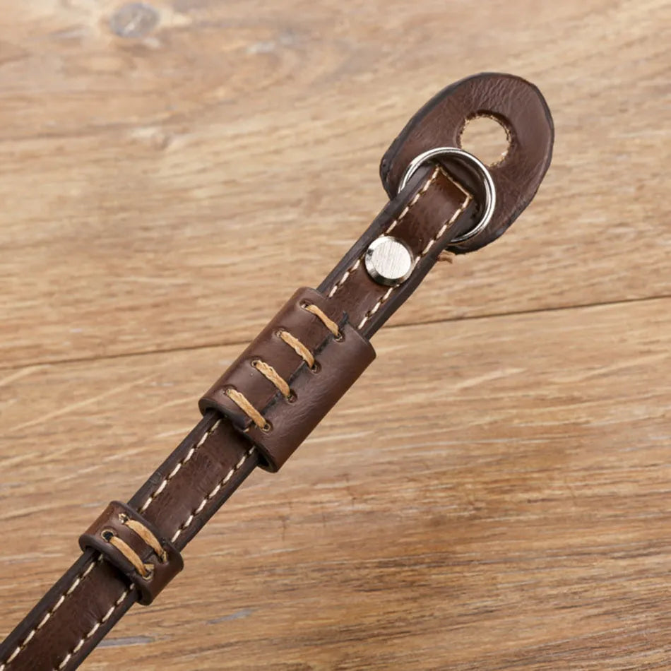 Adjustable black nylon wrist strap for digital cameras with metal slider buckle.