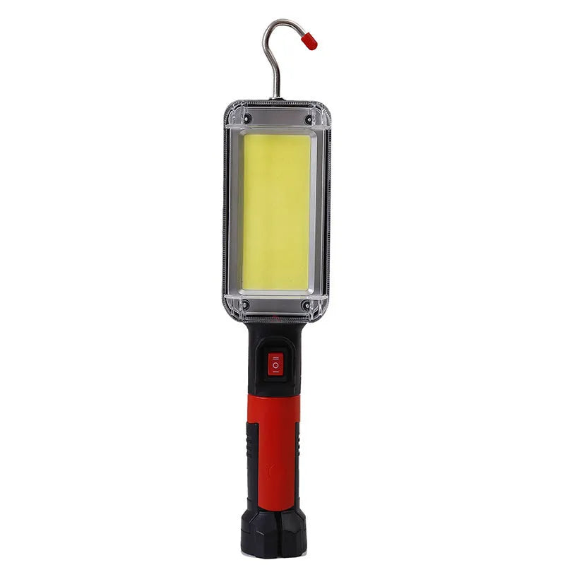 Red USB rechargeable COB LED flashlight with magnetic base shown on a metal surface.