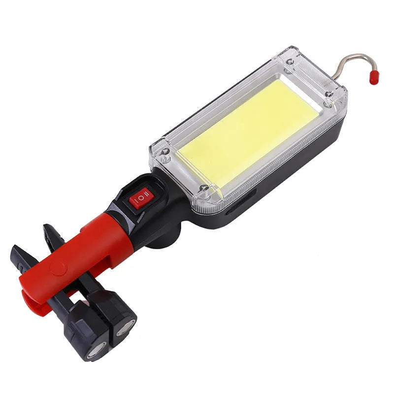 Red USB rechargeable COB LED flashlight with magnetic base shown on a metal surface.