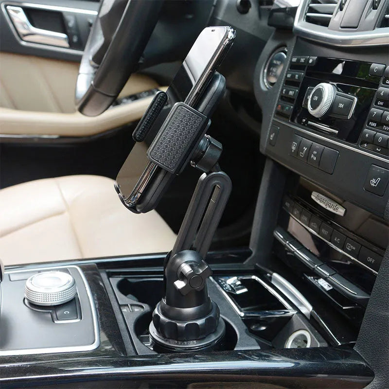 Black car phone holder with 360-degree rotating head and adjustable height on a car dashboard.