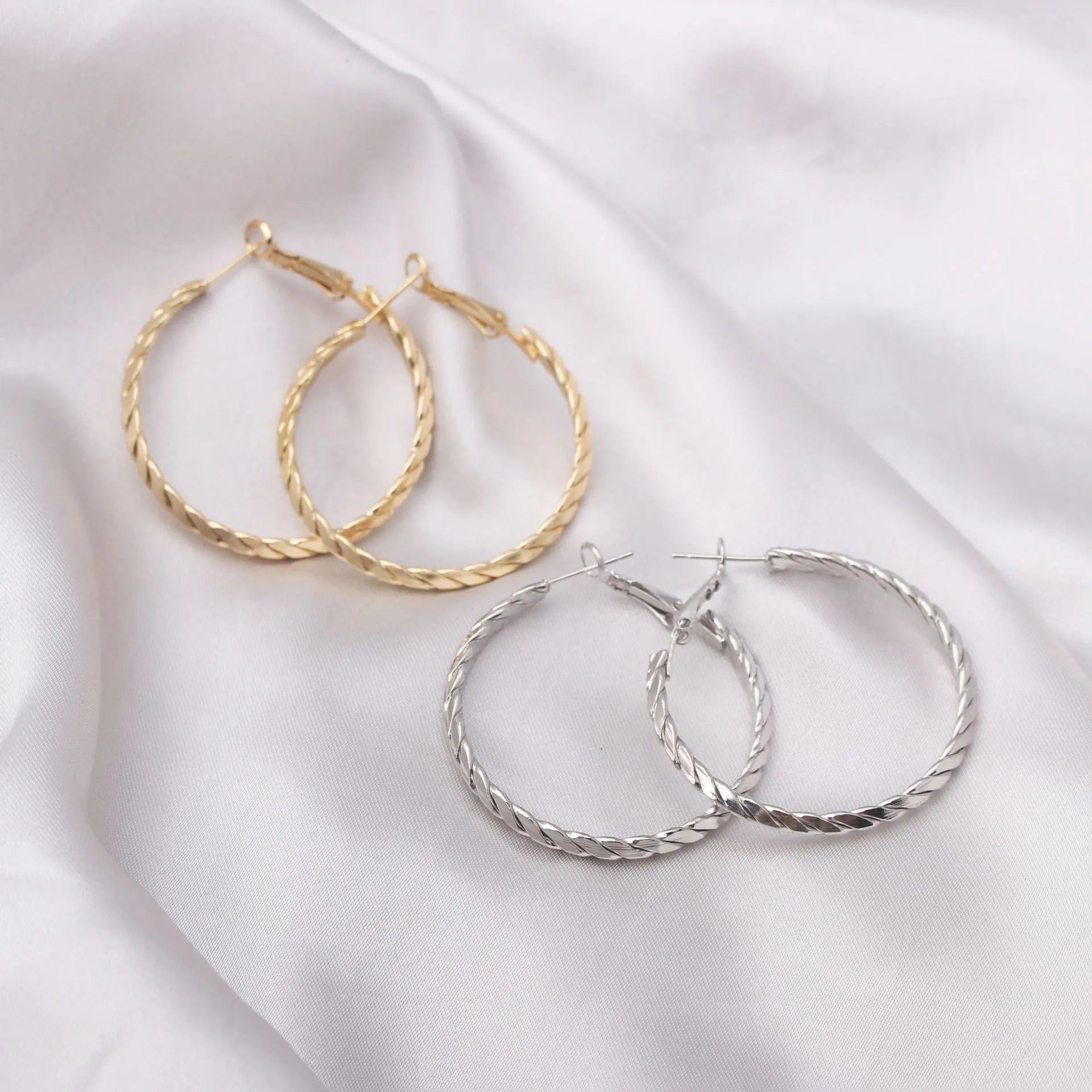 Geometric metal earring for women in gold with simple design and electroplated finish