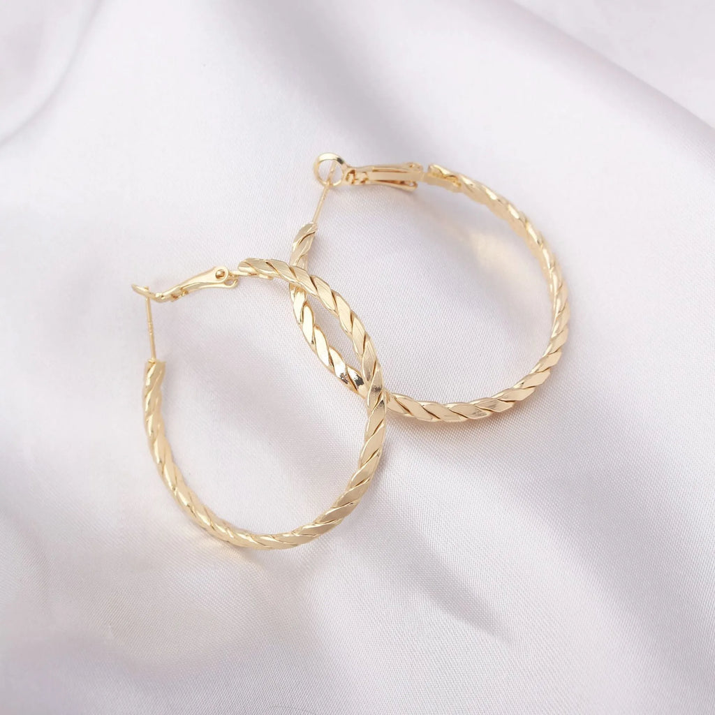 Geometric metal earring for women in gold with simple design and electroplated finish