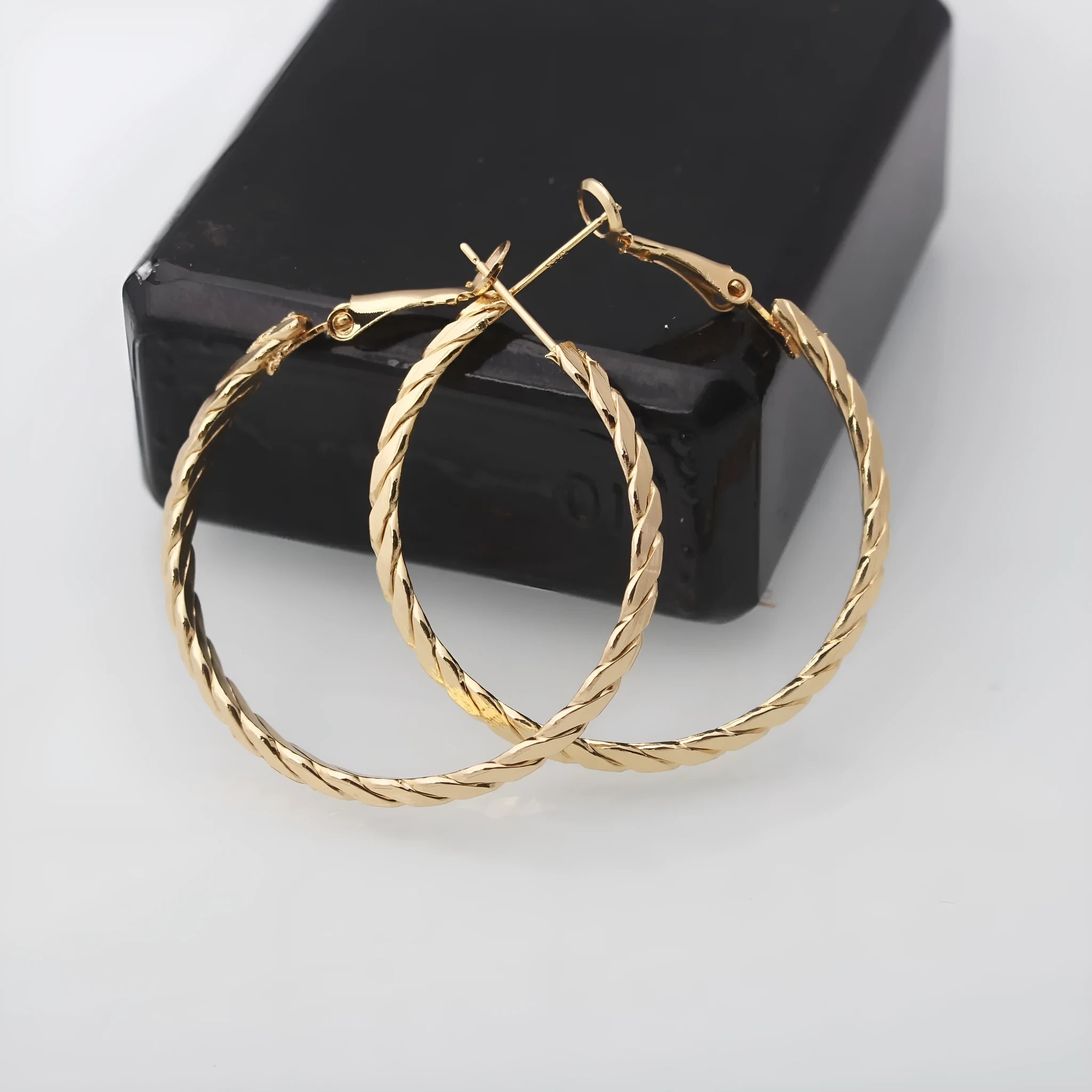 Geometric metal earring for women in gold with simple design and electroplated finish