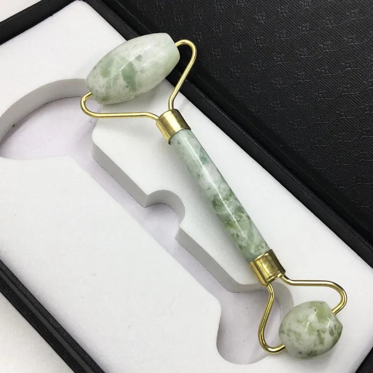 Xiuyu jade double-headed facial massage roller stick on white background