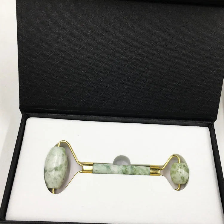 Xiuyu jade double-headed facial massage roller stick on white background