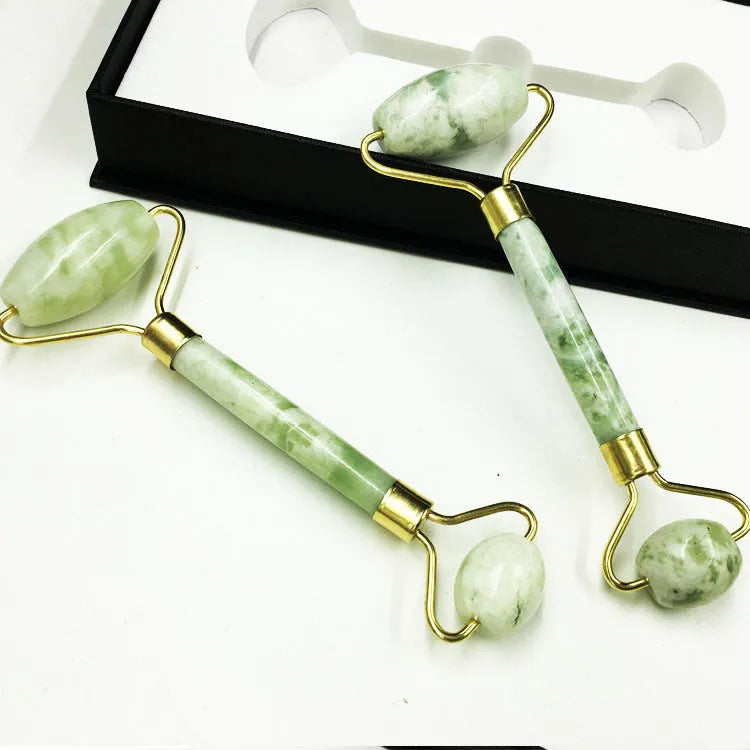 Xiuyu jade double-headed facial massage roller stick on white background