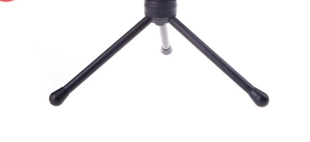 Black wired PC microphone with an adjustable clip-on holder on a desk.