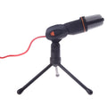 Black wired PC microphone with an adjustable clip-on holder on a desk.