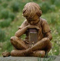 Brown resin garden statue of boy figure for tabletop decoration