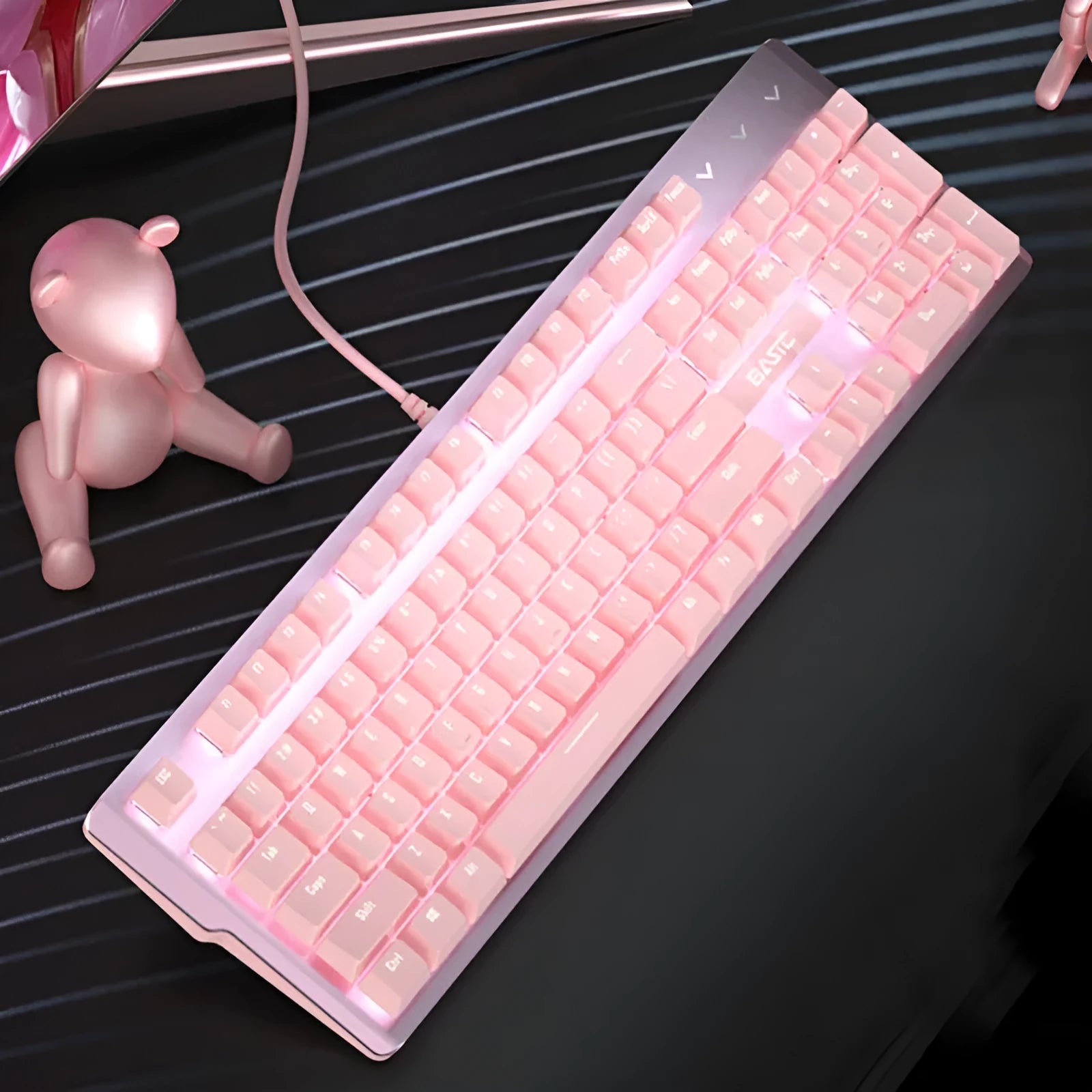 Pink wired mechanical keyboard and matching gaming mouse set on a desk.