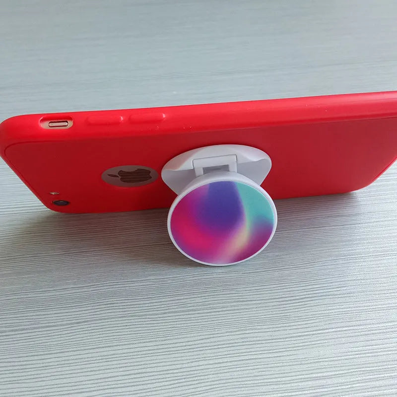 Folding mobile phone holder with thermal transfer aluminium sheet option in multiple colours on desktop