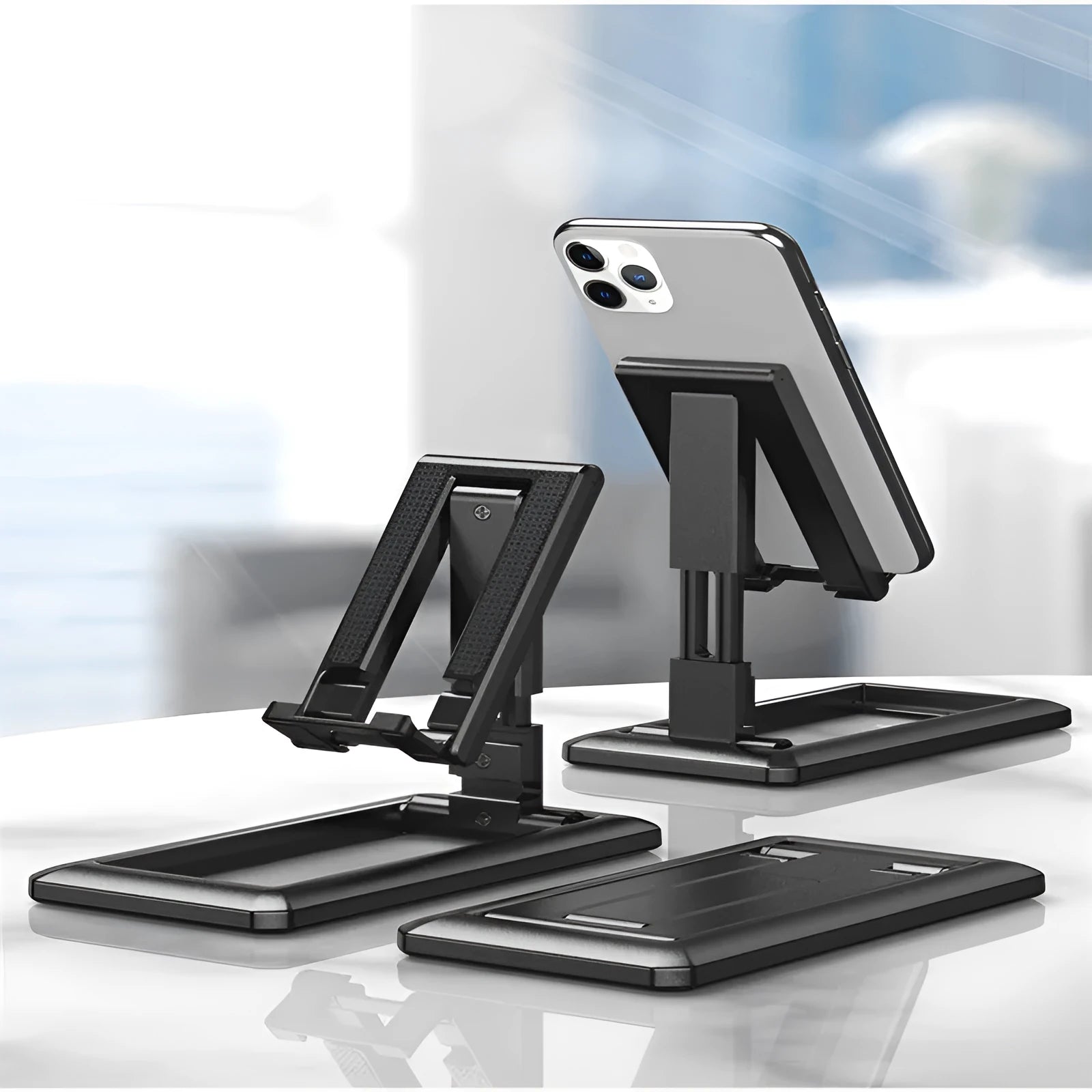 Retractable mobile phone desktop stand in collapsed and extended positions showing adjustable angle