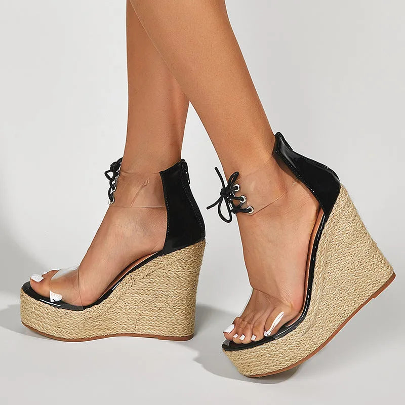 Black women's wedge sandals with hemp rope design, front tie, and a high wedge heel.
