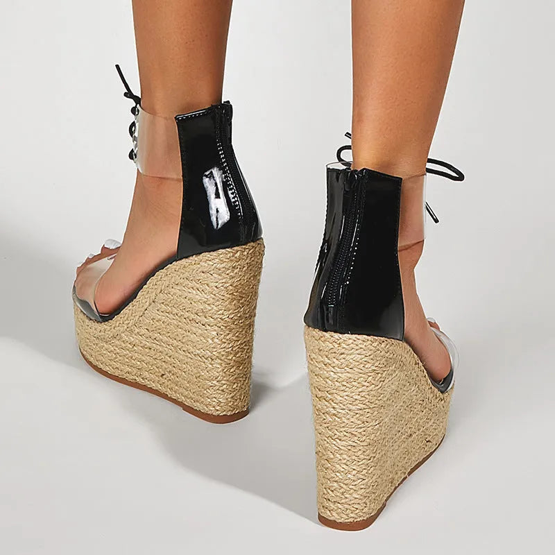 Black women's wedge sandals with hemp rope design, front tie, and a high wedge heel.