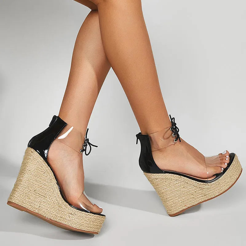 Black women's wedge sandals with hemp rope design, front tie, and a high wedge heel.