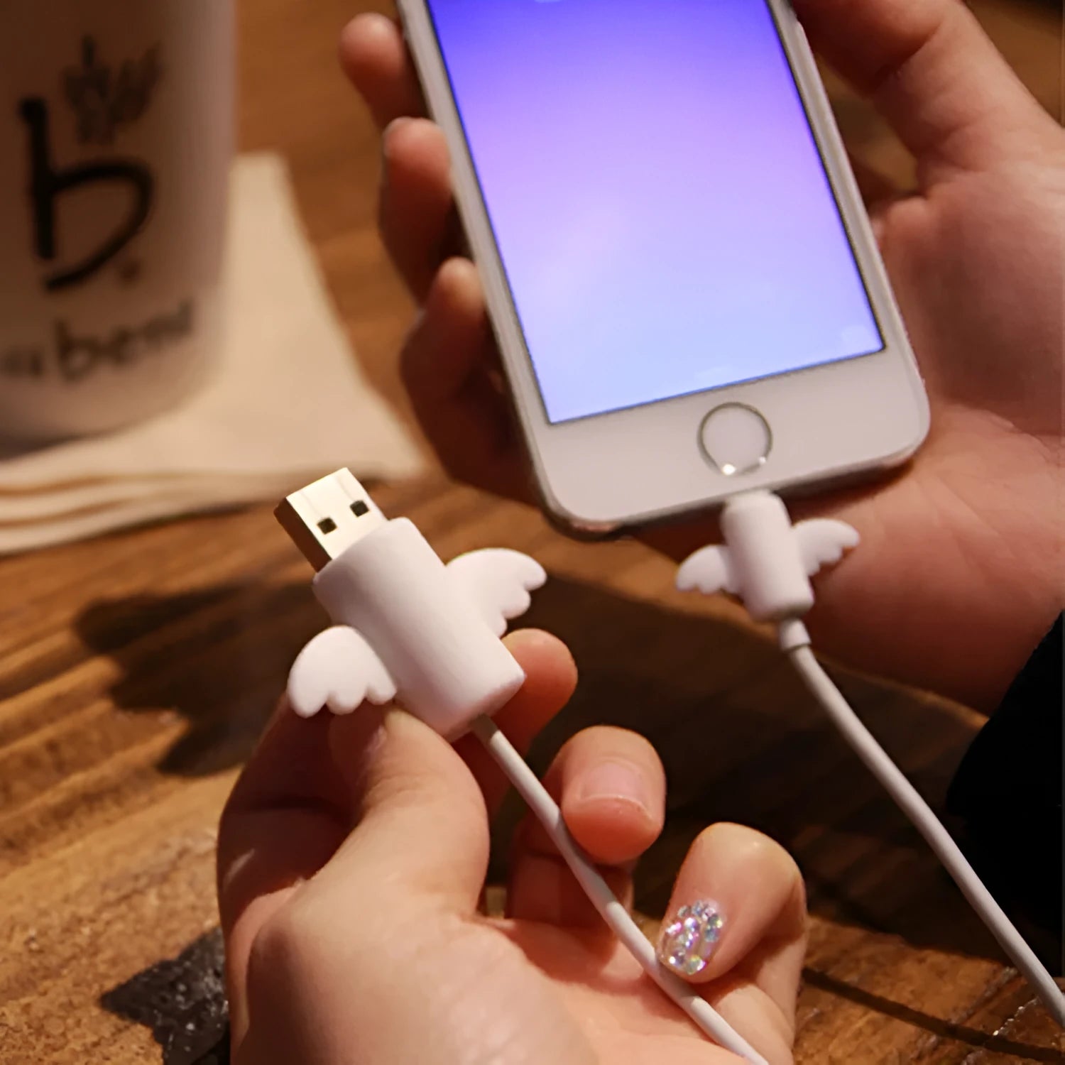 White and black silicone protective covers for mobile phone charging cables with size measurements