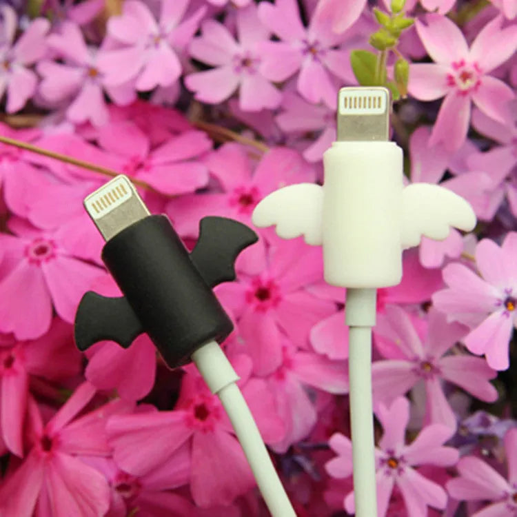 White and black silicone protective covers for mobile phone charging cables with size measurements