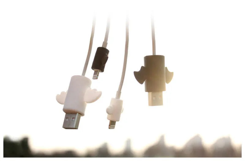 White and black silicone protective covers for mobile phone charging cables with size measurements