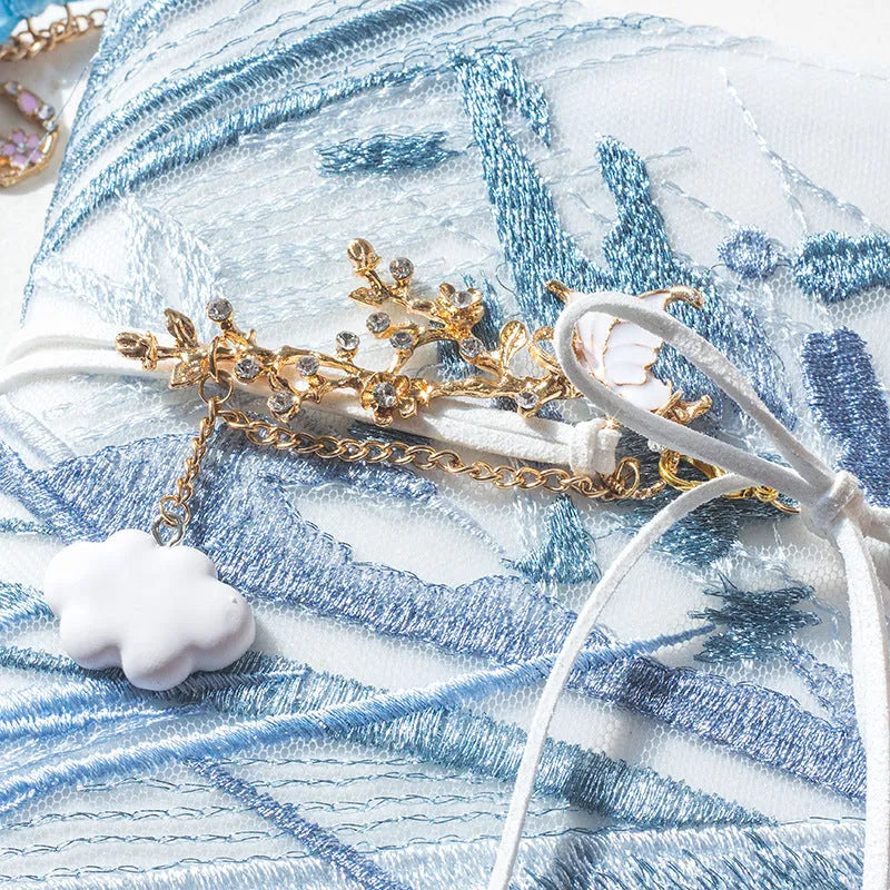 Glacier embroidery design on a fabric cover notebook lying open on a grid page.