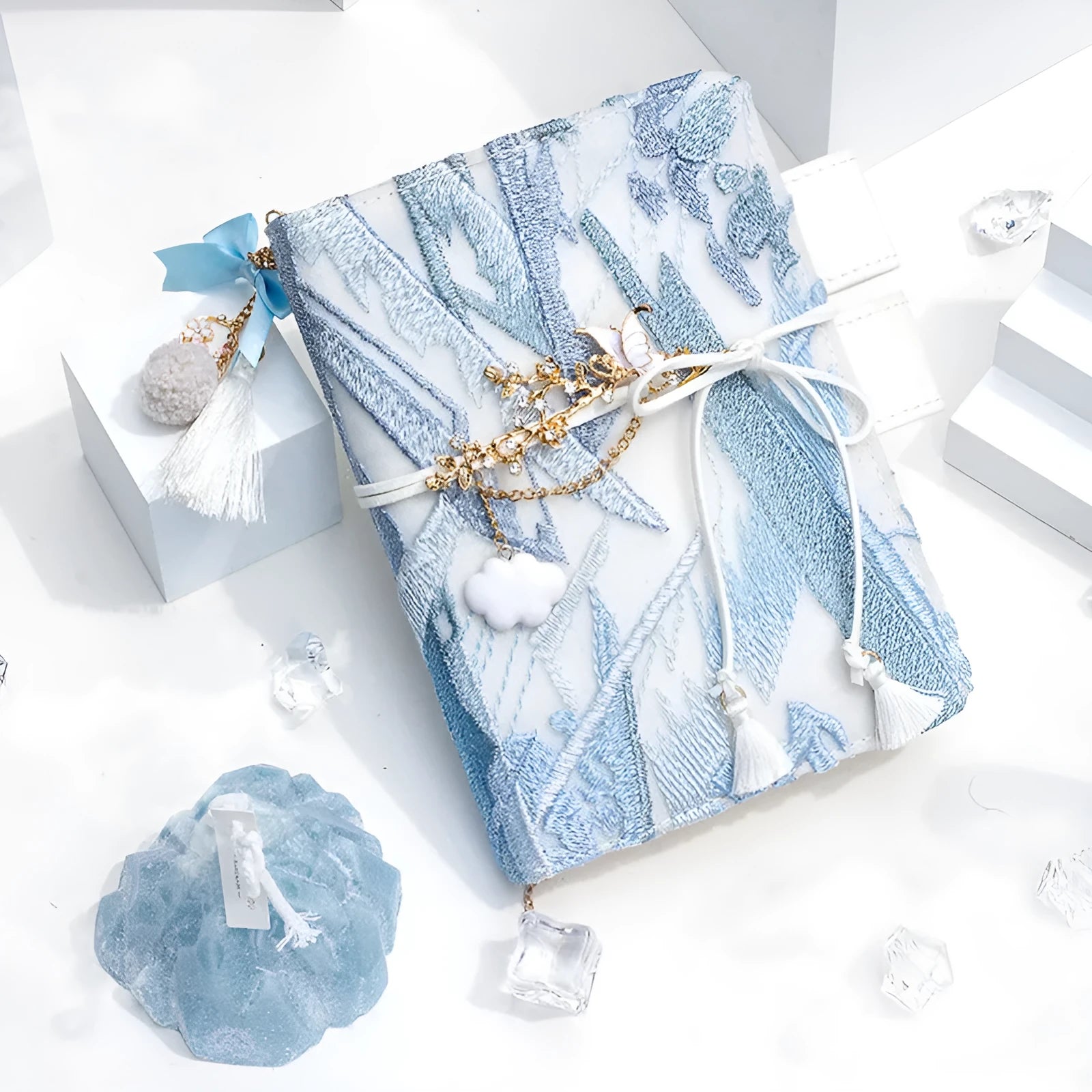 Glacier embroidery design on a fabric cover notebook lying open on a grid page.