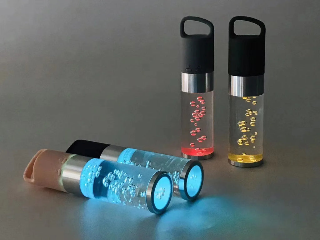 Compact colourful portable Bluetooth speaker with a crystal light in pink, black, silver grey, or green.