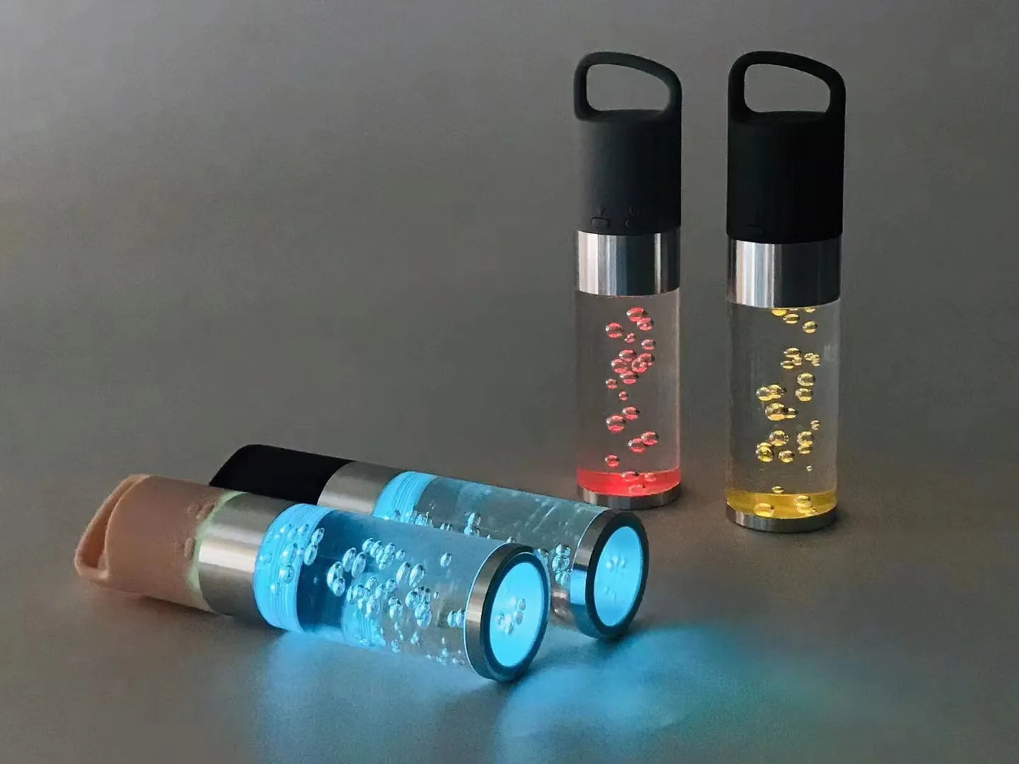 Compact colourful portable Bluetooth speaker with a crystal light in pink, black, silver grey, or green.