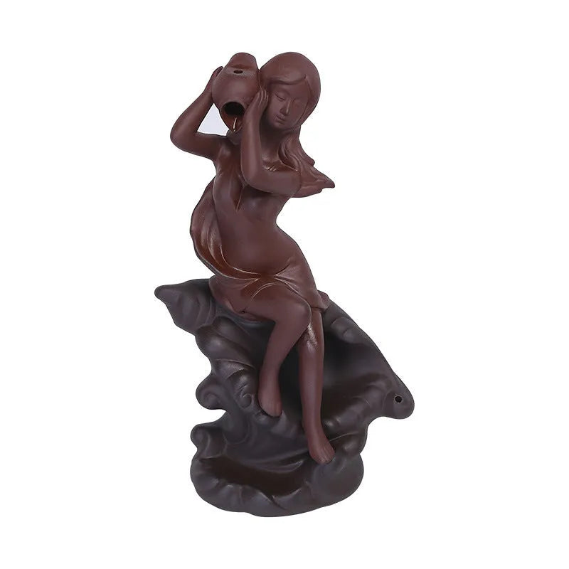 Red handmade ceramic snail-shaped backflow incense burner on a table