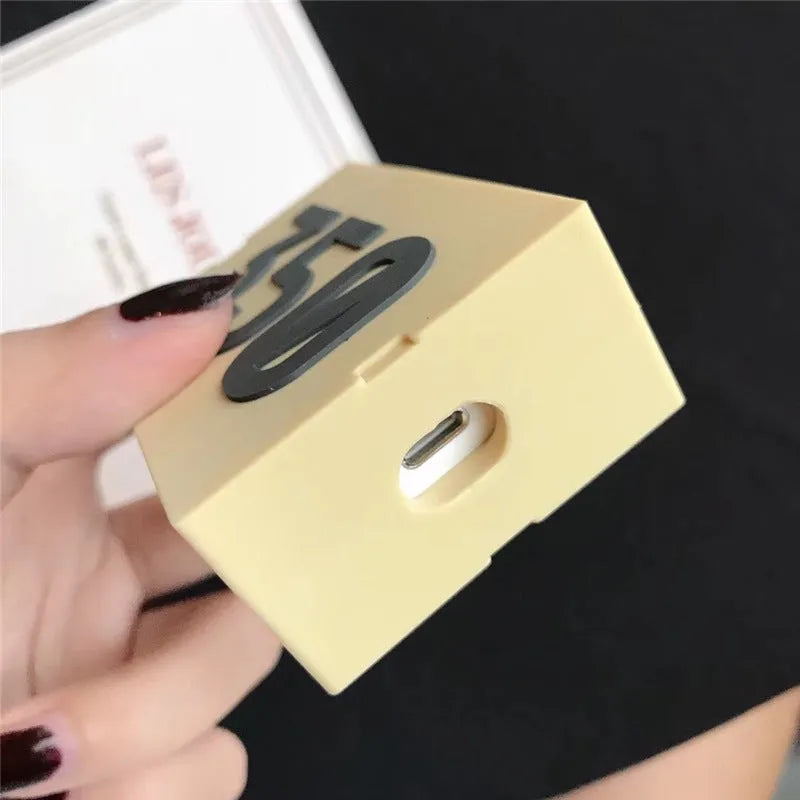 Solid colour silicone protective sleeve for AirPods 1 and 2 with a metal carabiner clip attached.