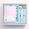 Peekaboo gift box containing a hand ledger notebook and a pen, notebook measures 13 by 18 centimetres.