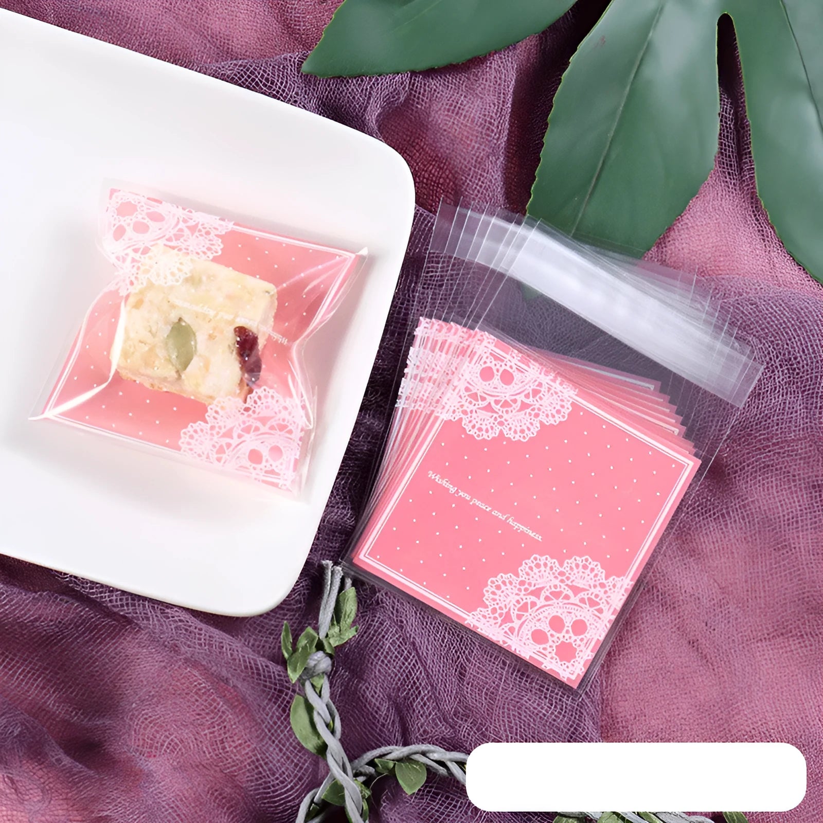 Pack of 100 small pink self-adhesive plastic bags for soap or snack packaging.