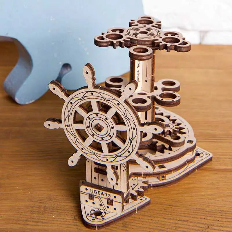 Ukrainian wooden rotating pen holder model kit with steering wheel, shown disassembled for building.
