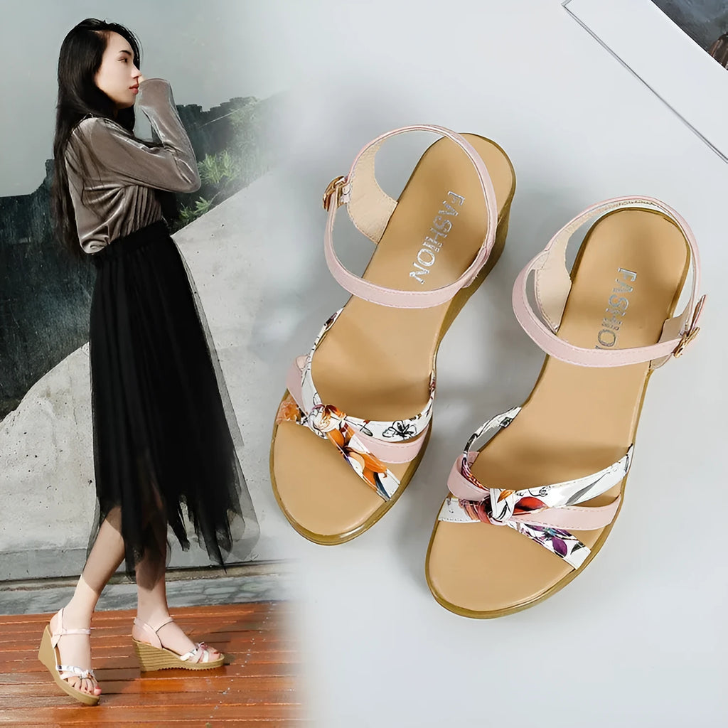 Women's pink wedge sandals with a thick heel and buckle closure on a white background.
