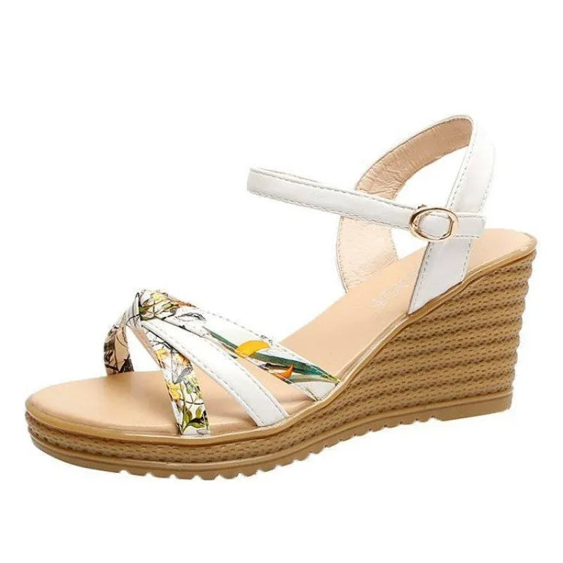 Women's pink wedge sandals with a thick heel and buckle closure on a white background.