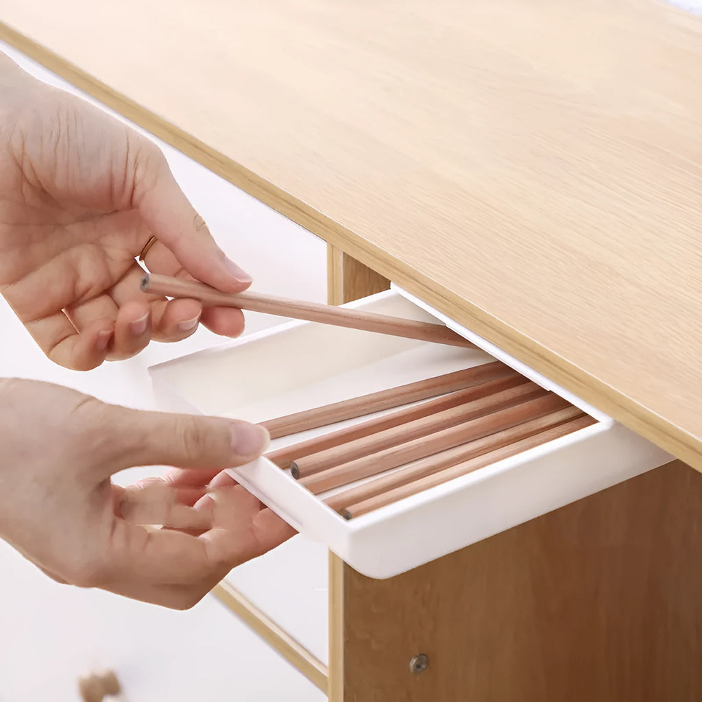 Grey Japanese style plastic storage box for stationery on a wooden desk.